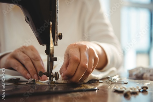 Female dressmaker sewing in the studio photo