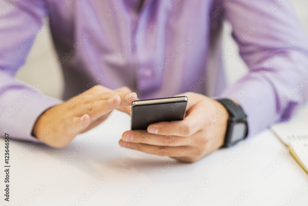 Close up view of businessman hands holding smart phone. Close up view of businessman hands holding smart phone.