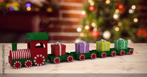 Composite image of train model carrying gift boxes photo