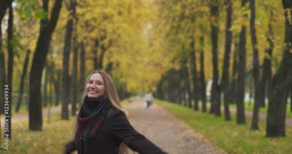 teenage girl enjoying autumn and spinning around teenage girl enjoying autumn and spinning around