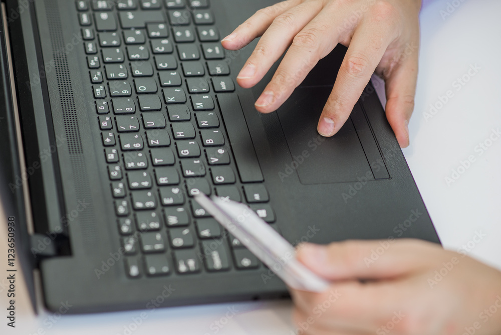 Man Using Credit Card to Make Purchase with Laptop Man Using Credit Card to Make Purchase with Laptop