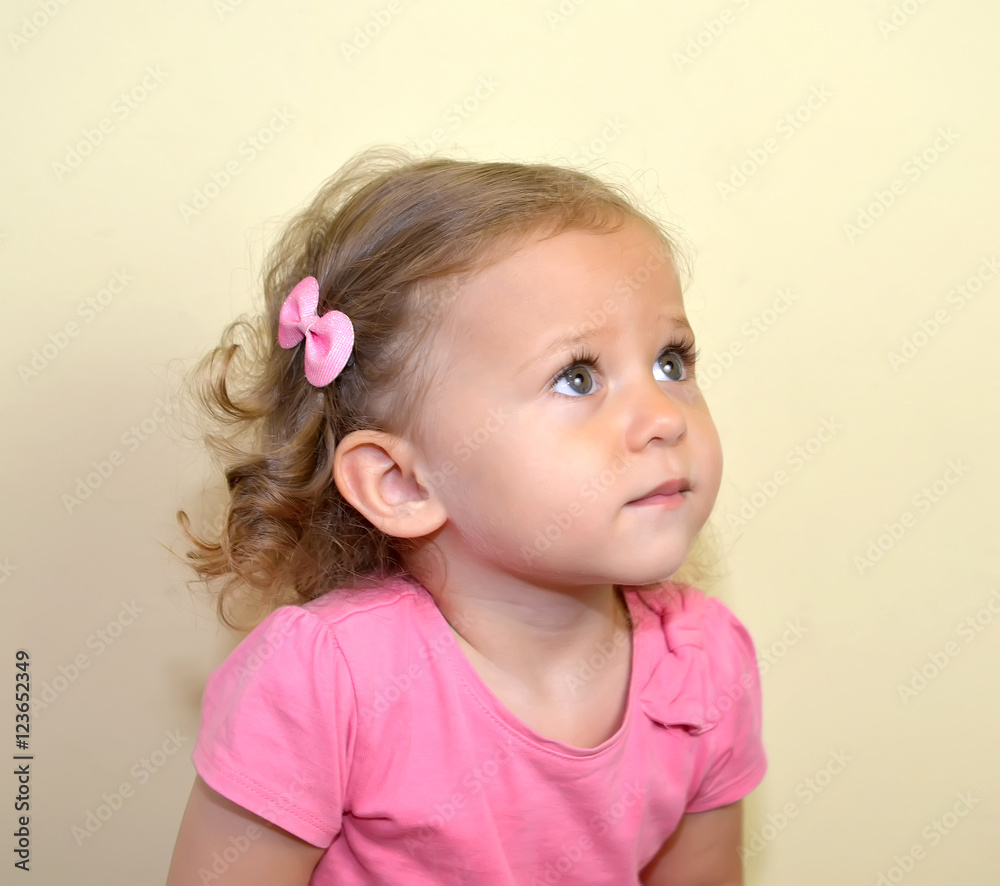 Portrait of the two-year-old girl on a light background Portrait of the two-year-old girl on a light background