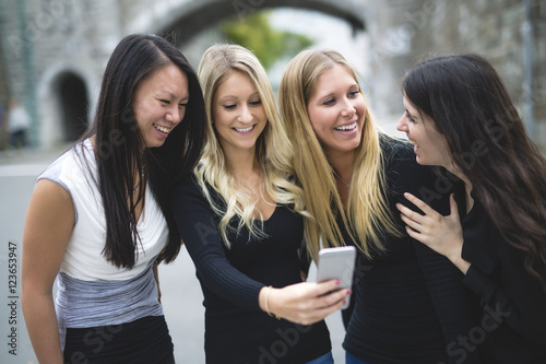 Four young good girl friend people in the city