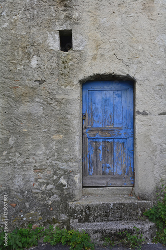An old wooden door in a derelict building the village of Oblizza, Friuli, north east Italy. 
