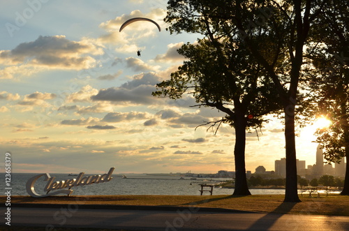 Morning view of Cleveland skyline, lake Erie, and paraglider from Edgewater park