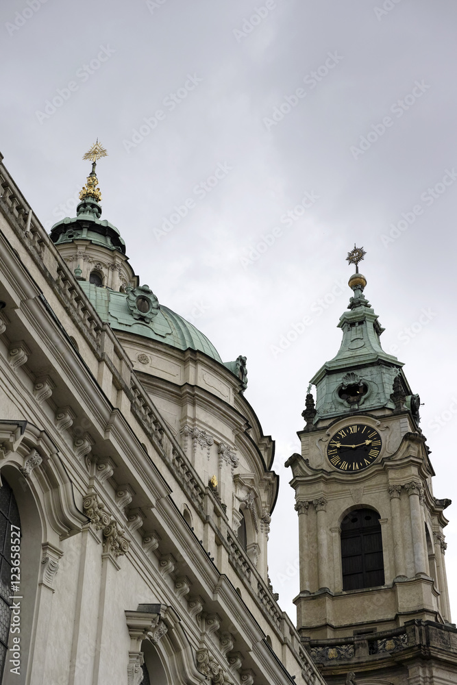 The dome and clock tower of St Nicholas church in the City of Prague, Czech Republic