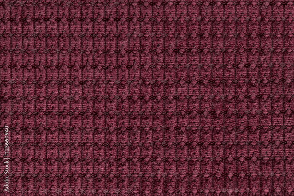 Dark red background from soft fleecy fabric close up. Texture of textiles macro