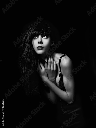 Dramatic portrait of beautiful scared goth girl among the dark © jetrel2