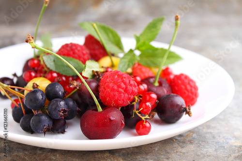 Concept of healthy vegan dessert  raspberry  cherry  red currant. Selective focus