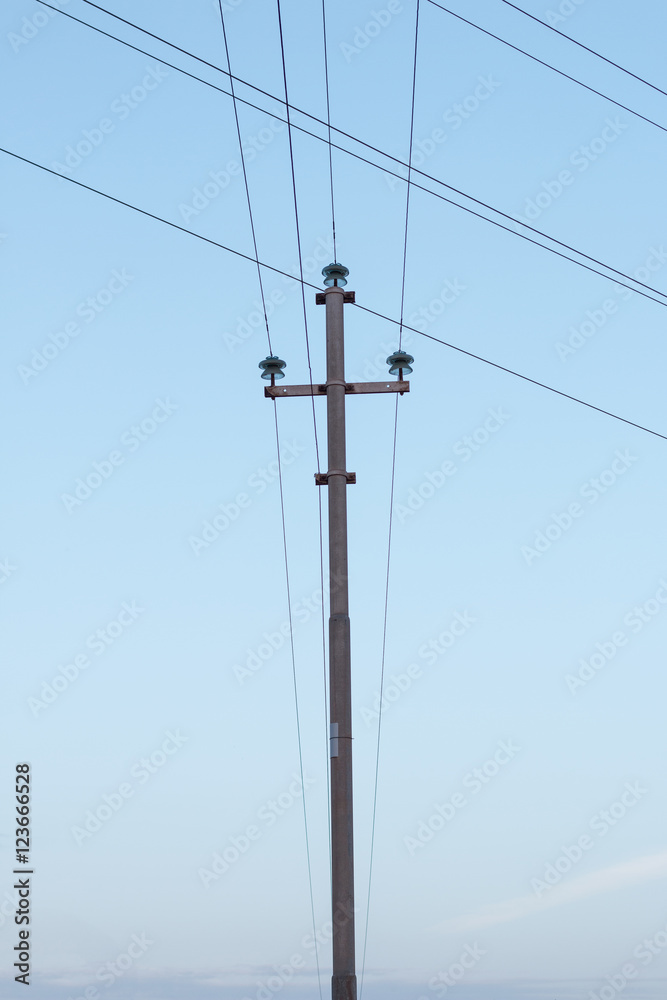 Electricity post in the middle of the frame with a blue sky Electricity post in the middle of the frame with a blue sky