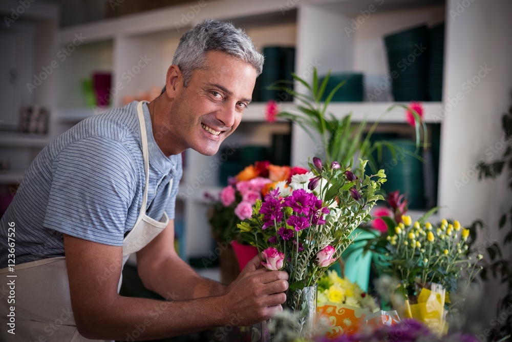 Happy florist preparing a flower bouquet Happy florist preparing a flower bouquet