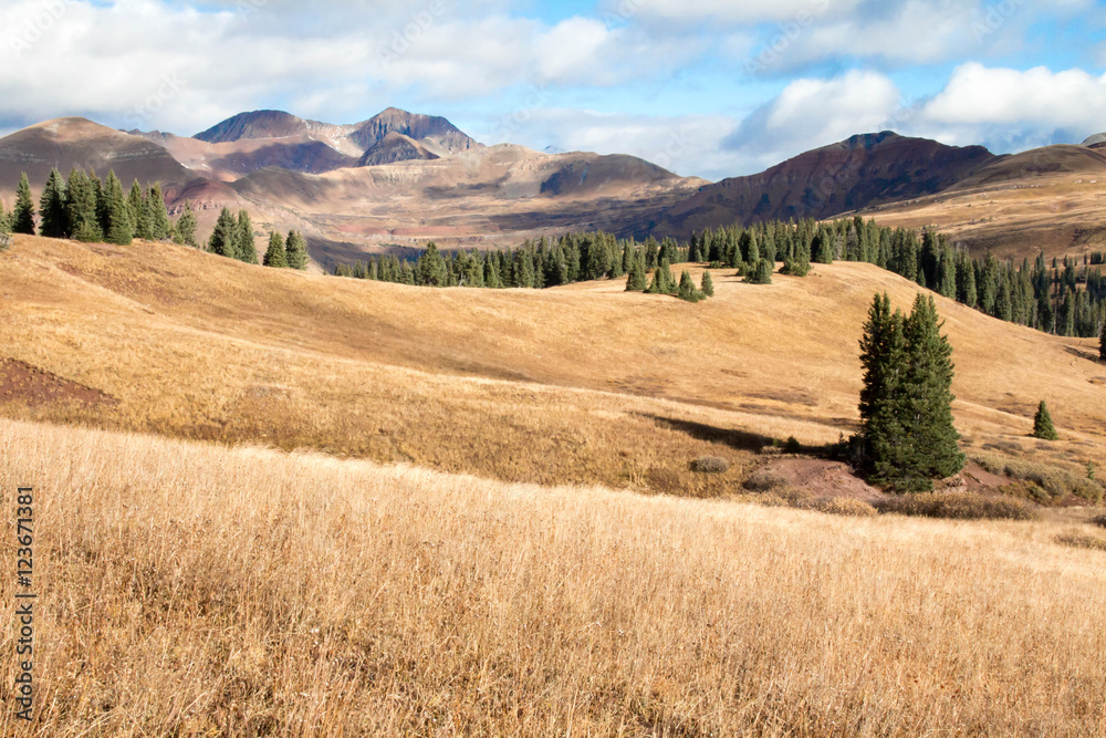 Rolling brown grassland and mountains in Colorado Rolling brown grassland and mountains in Colorado