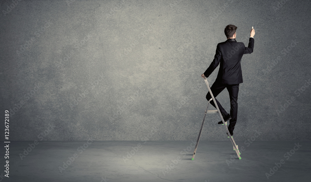businessman drawing on grunge wall businessman drawing on grunge wall