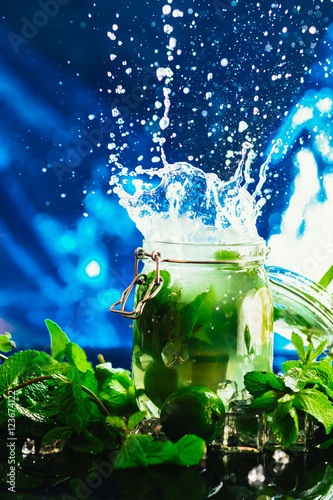 Bank mojito with lime and mint ice cube falling splash