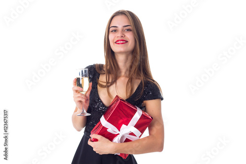Young woman holding a present and a glass of champagne © Dmitry Bairachnyi