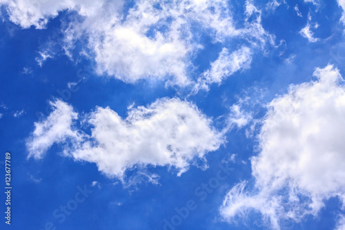 Blue sky background with white clouds. The vast blue sky and clouds sky on sunny day. White fluffy clouds in the blue sky.