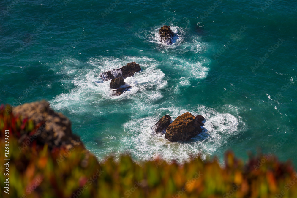 Watersplashes from waves crushing over rocks in the ocean