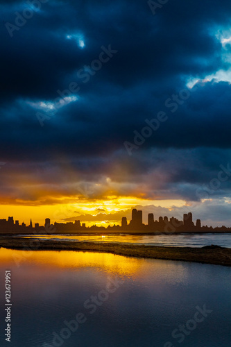 City Skyline at Sunrise or Sunset with Water in Foreground