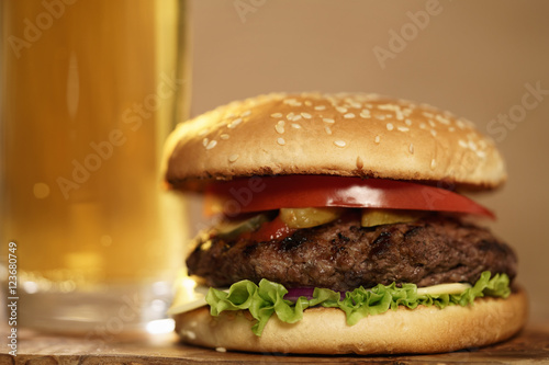 homemade hamburger with beer on background