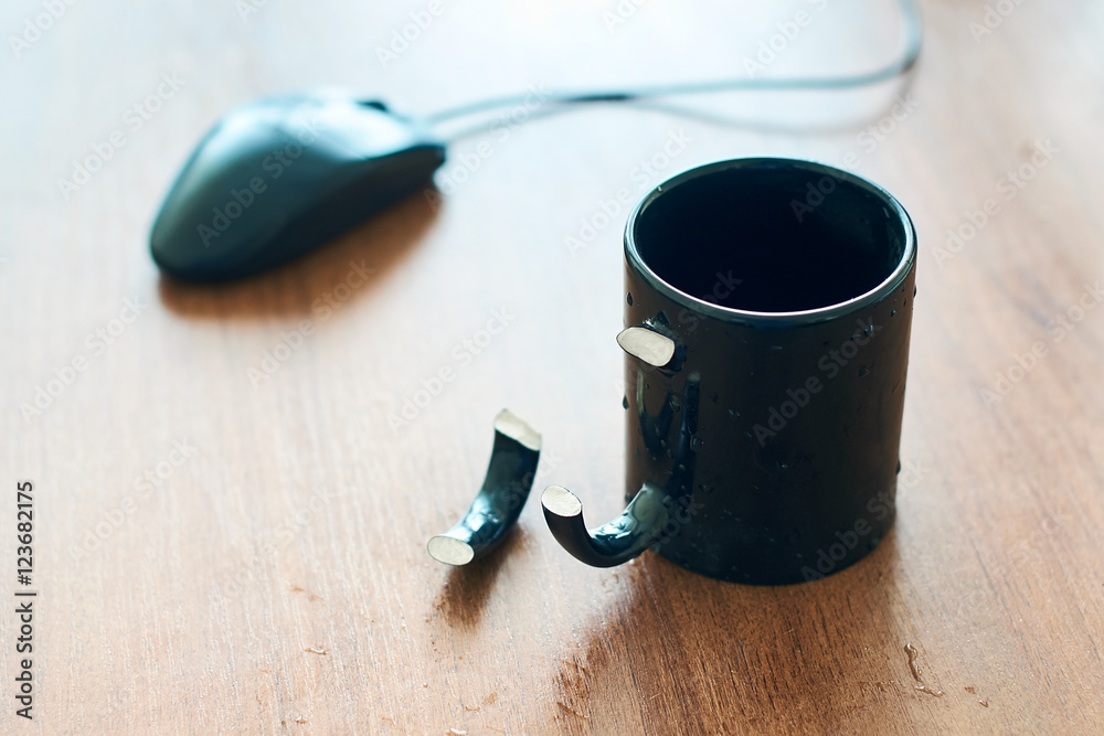 Cup with broken handle on the office table