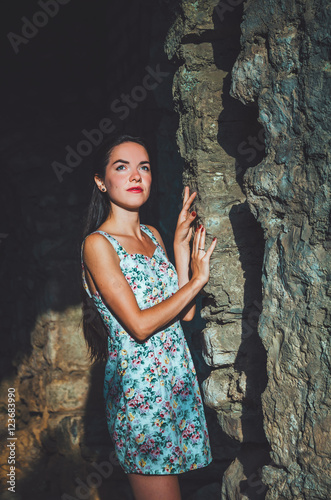 Attractive woman in Stari Bar old fortress, Montenegro. Brunette female with long hair in dress walks around castle, the magic atmosphere and fairy tales.
