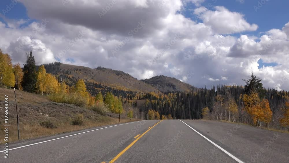 Mountain road autumn colors lake POV. Beautiful season Autumn fall colors in Aspen Pine forest. Exploring natural scenic landscape before winter. Mountain road autumn colors lake POV. Beautiful season Autumn fall colors in Aspen Pine forest. Exploring natural scenic landscape before winter.