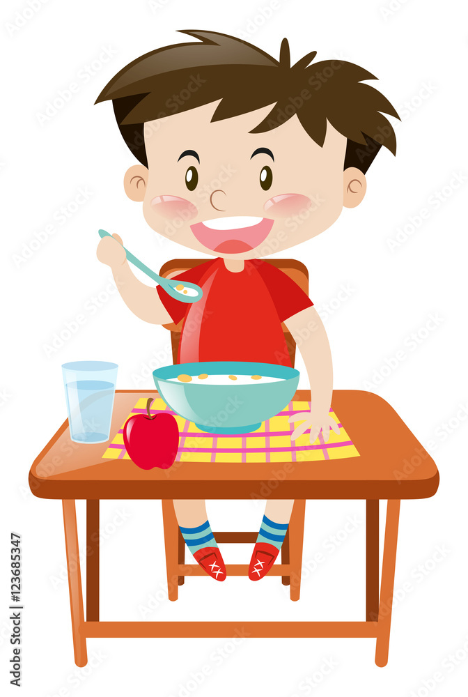 Boy eating from bowl on the table Boy eating from bowl on the table