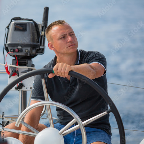 Skipper drive a sailing boat..