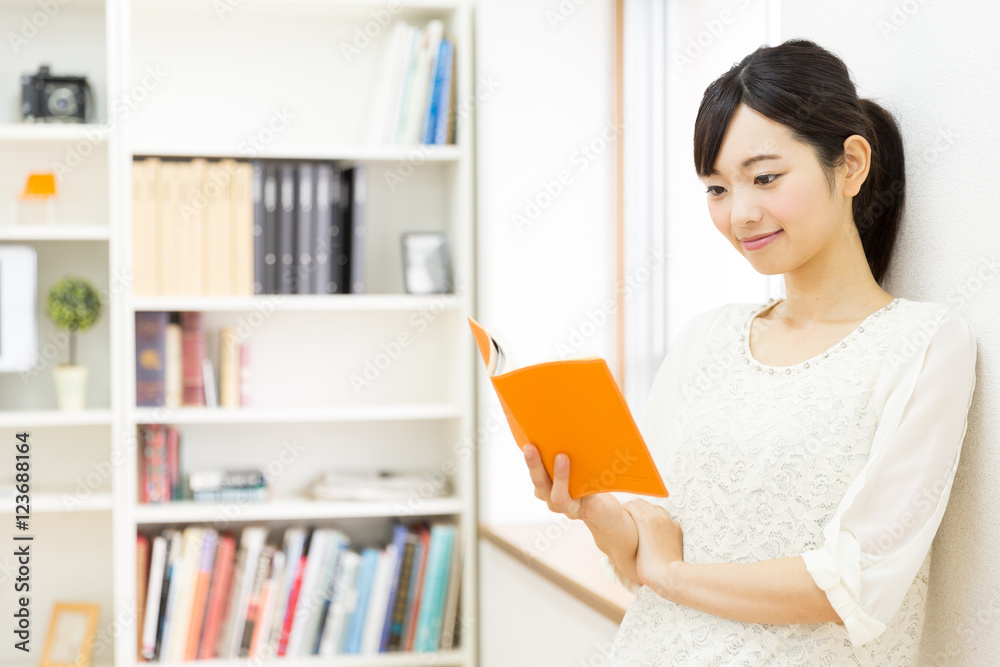 attractive asian woman reading book