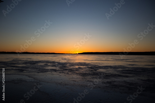 Sunset over a frozen lake in winter