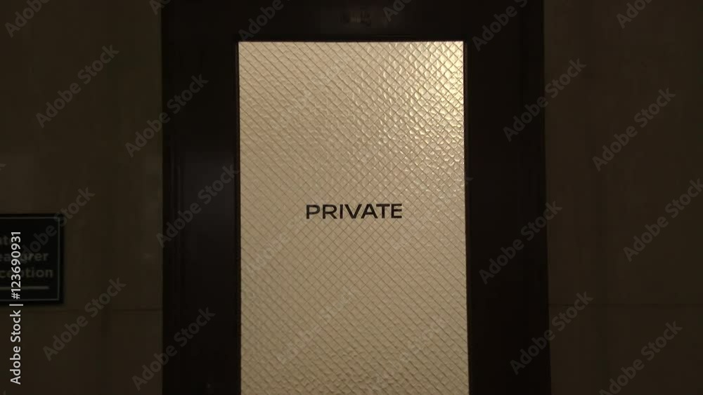 Door read Private inside government building with camera zoom in.