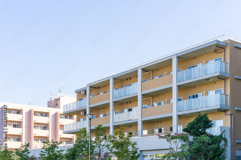 Fototapeta premium Residence image, apartment building against blue sky