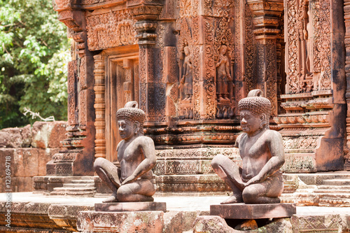 Ancient pink stone guardian statue carvings in Banteay Srei, Siem reap, Cambodia.