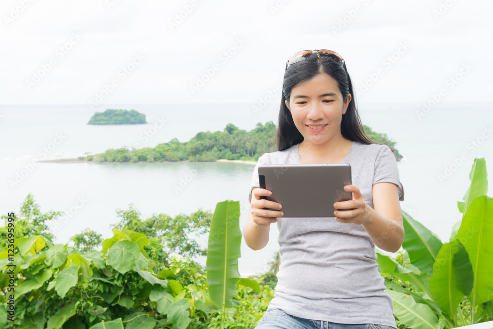 Fototapeta premium asian woman selfie with seascape against blue sky
