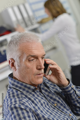 Senior office worker on the phone