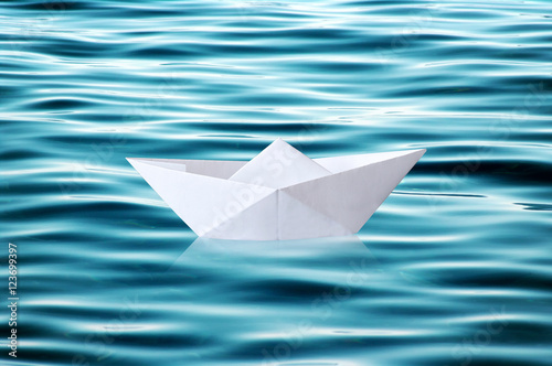 Paper boat floating on rippled water © photology1971