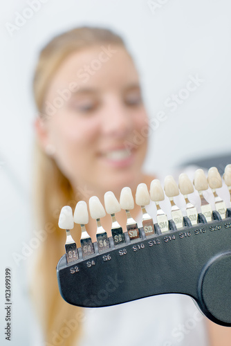 Unfocused lady behind sample teeth