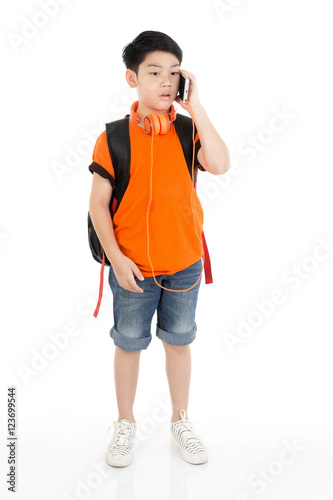 Happy asian boy using cell phone .