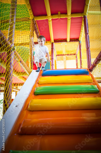 Little kid climbing on stairs in kindergarden playground © Jasmin Merdan