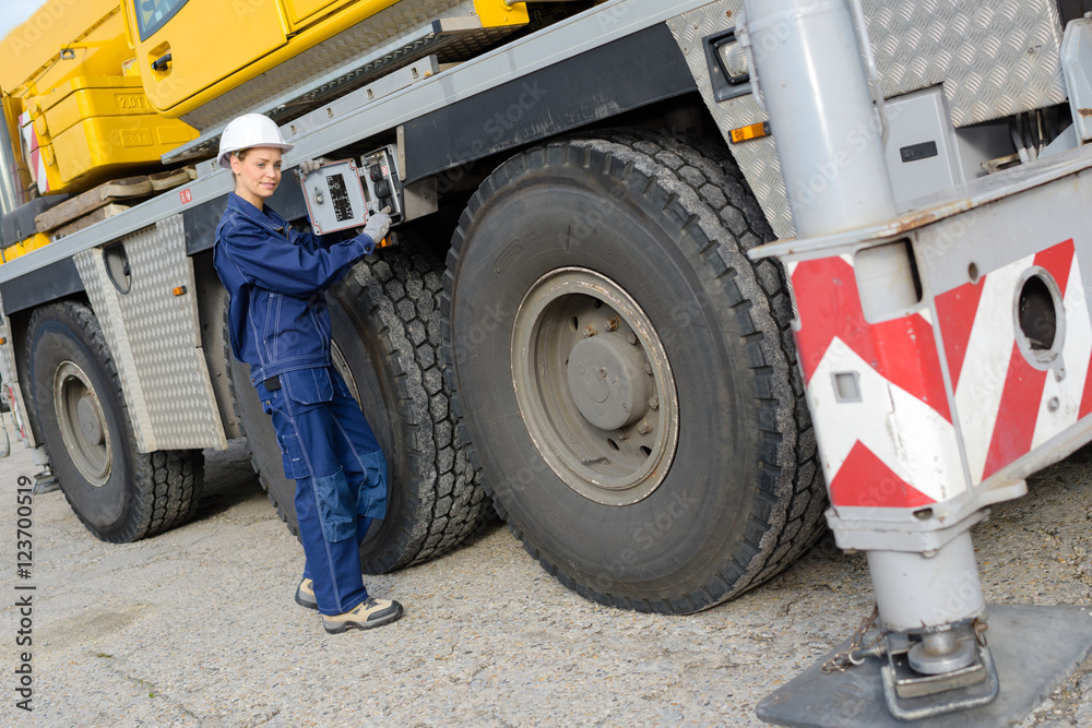 female worker inspecting her truck before driving