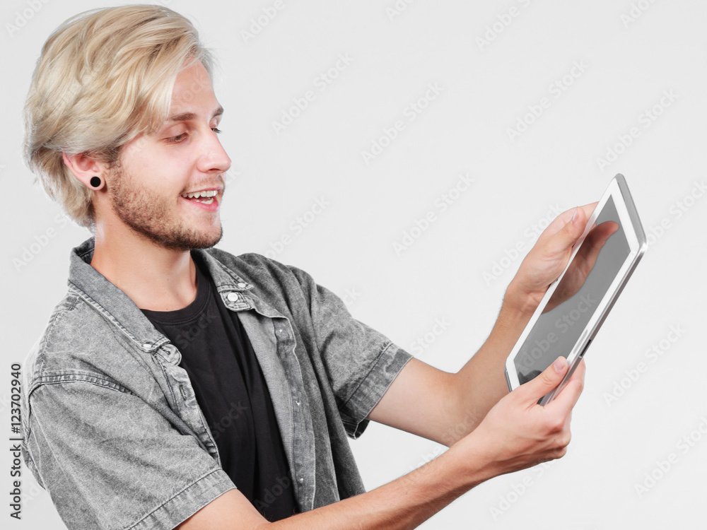 Trendy young man using tablet computer Trendy young man using tablet computer