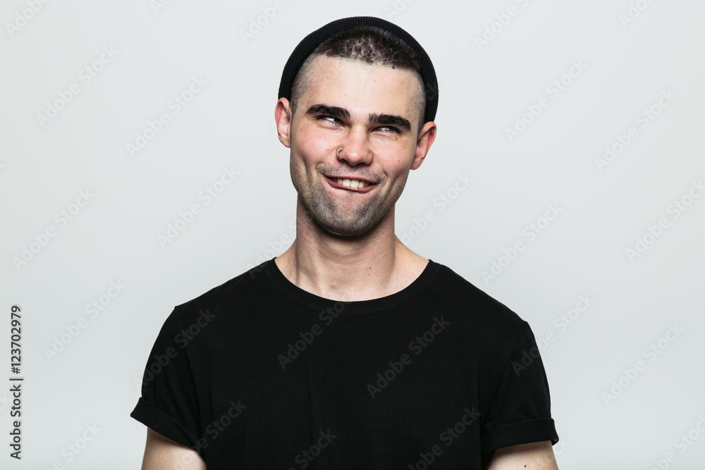 Obraz premium Studio portrait of adult man making smiling face on white background.