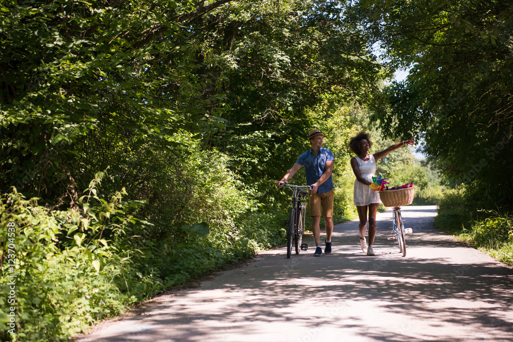 Young multiethnic couple having a bike ride in nature Young multiethnic couple having a bike ride in nature
