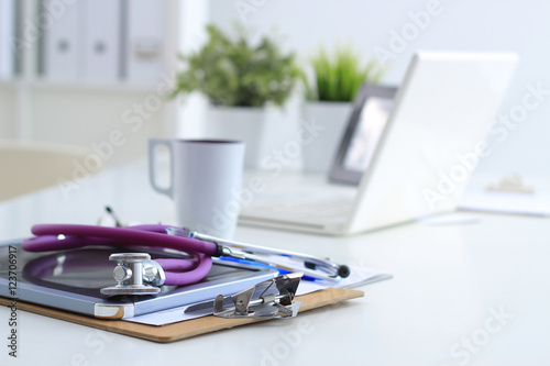 Stethoscope , laptop, folder on the desk in hospital