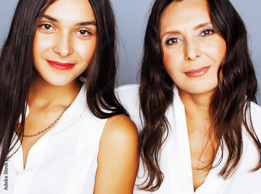 cute pretty teen daughter with mature mother hugging, fashion st cute pretty teen daughter with mature mother hugging, fashion st