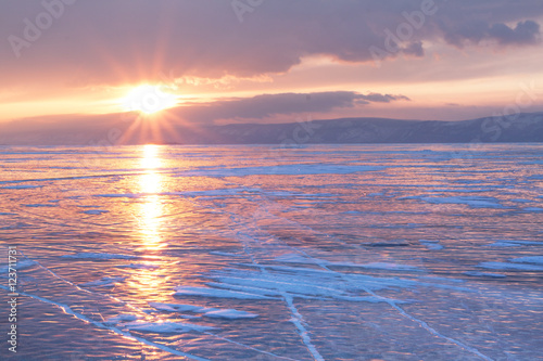 Beautiful sunset above the frozen surface of the lake Baikal on the Olkhon iceland