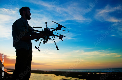 manholding a drone for aerial photography. 