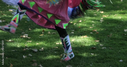 Teenage Native American girls traditional dance. Historic culture shared at public demonstrations. Dancers mimic animals or birds or working of hunting, fishing, planting and harvesting. photo