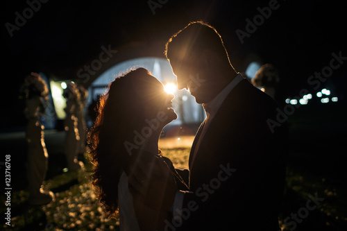 The lovely couple in love embrace near archway photo