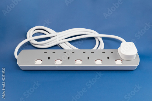 UK extension lead on blue background photo